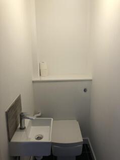 Compact and neat single toilet with a modern wh...