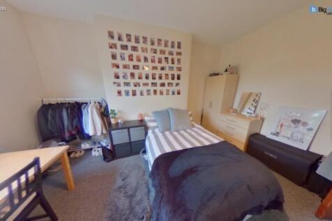A cozy and inviting bedroom featuring a neatly ...