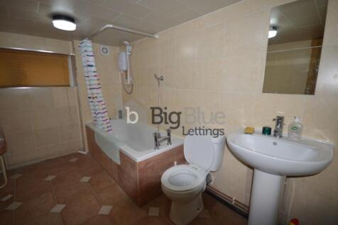 A bathroom suite featuring a bathtub with showe...