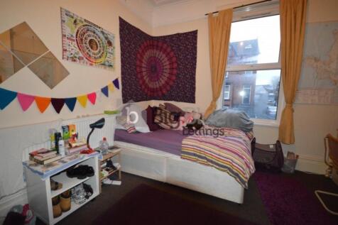 A cozy single bedroom featuring a neatly made b...