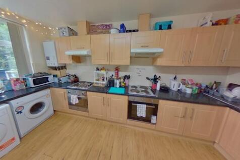 Bright and functional kitchen with ample wooden...