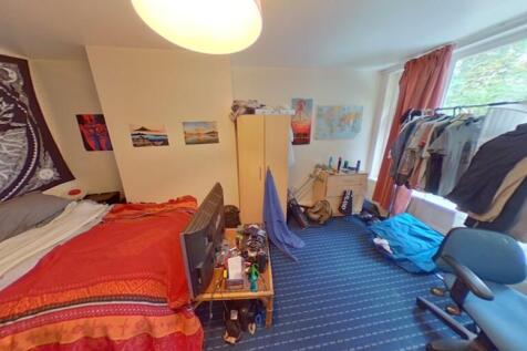 A bright, cozy double bedroom featuring a large...