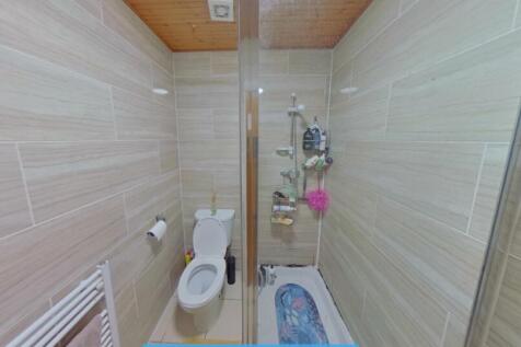 A modern bathroom featuring a walk-in shower wi...