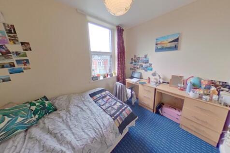 Bright and cozy single bedroom featuring a comf...