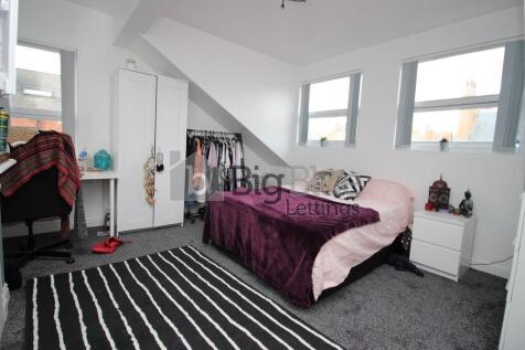 A bright and cozy double bedroom featuring a co...