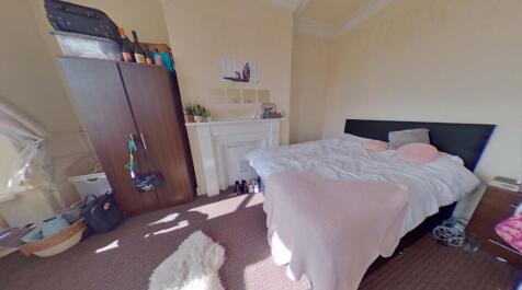 Bright and cozy master bedroom featuring a spac...
