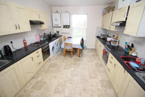 Bright and spacious kitchen featuring ample cou...