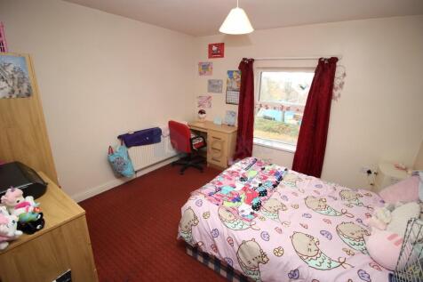 Cozy single bedroom featuring a comfortable bed...