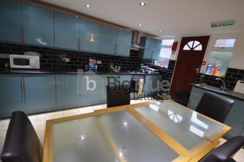 A modern kitchen featuring sleek cabinetry with...