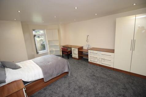A spacious and well-lit double bedroom featurin...