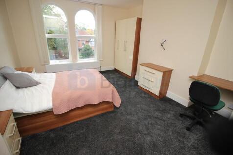 A bright and welcoming double bedroom featuring...