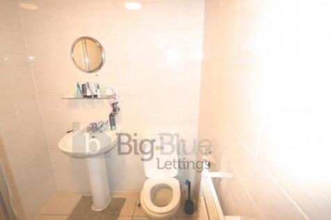 A clean and bright single toilet featuring a wh...