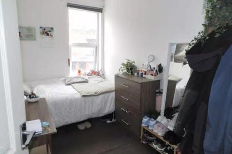 Cozy single bedroom featuring a comfortable bed...