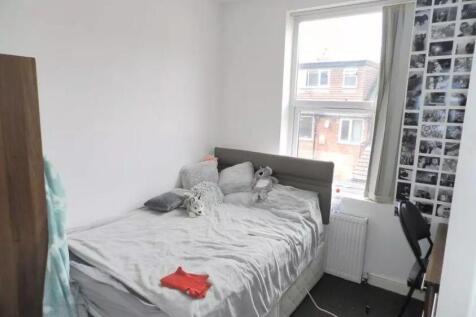 A bright single bedroom featuring a comfortable...