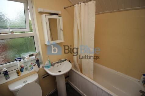 A neat and functional bathroom featuring a whit...