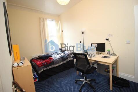 Cozy single bedroom featuring a comfortable bed...