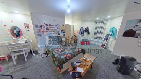 A cozy and spacious master bedroom featuring a ...