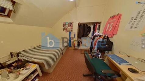 Cozy single bedroom featuring a comfortable bed...