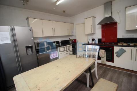 A modern kitchen featuring ample cabinetry, a l...