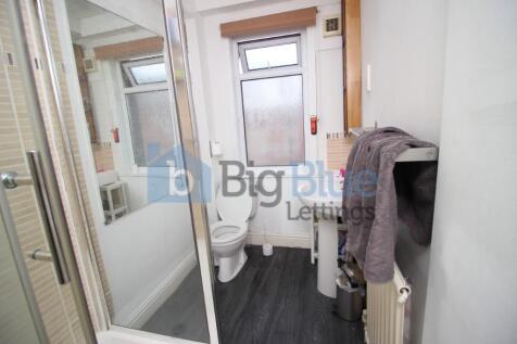 A clean and functional bathroom featuring a sho...