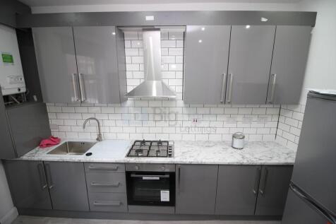 Modern kitchen featuring sleek grey cabinetry a...