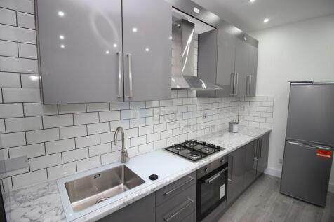 A modern kitchen featuring sleek grey cabinetry...