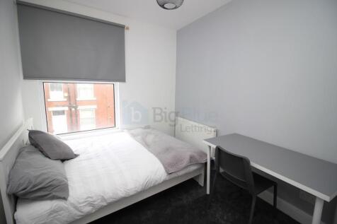 A neat and modern double bedroom featuring a co...
