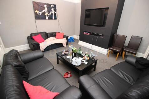 A cozy living room featuring black leather sofa...
