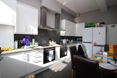 Bright and modern kitchen featuring white cabin...