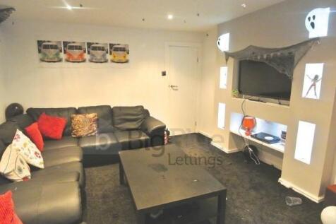 Contemporary living room featuring a large, com...