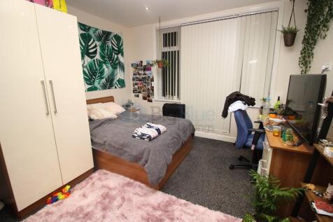 A cozy and well-organized bedroom featuring a d...
