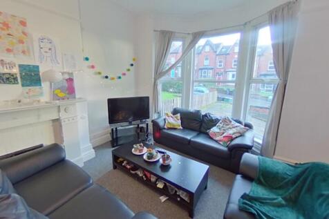 Bright and inviting living room featuring large...