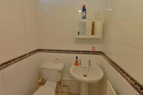 A clean and well-maintained single toilet with ...
