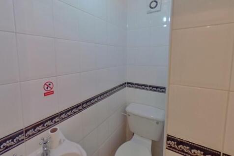 A clean and functional single toilet room featu...