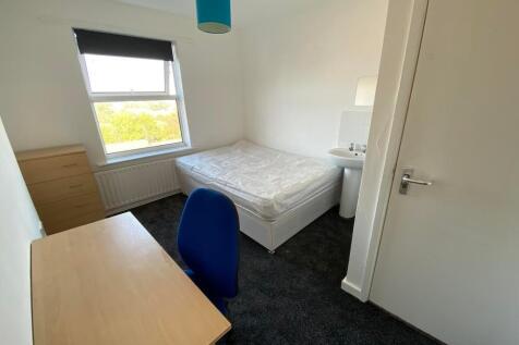 Bright and neat bedroom featuring a comfortable...