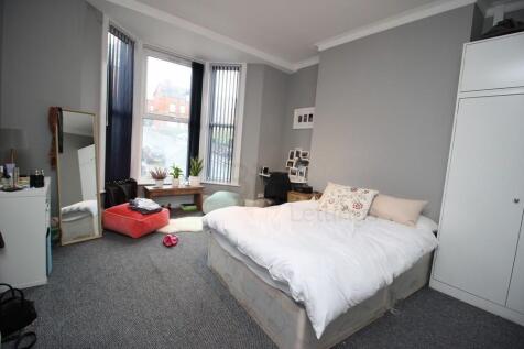 A bright and cozy double bedroom featuring a co...
