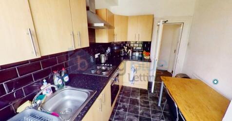 A well-maintained kitchen featuring modern cabi...