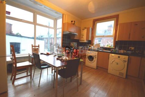 Bright and inviting kitchen featuring large win...