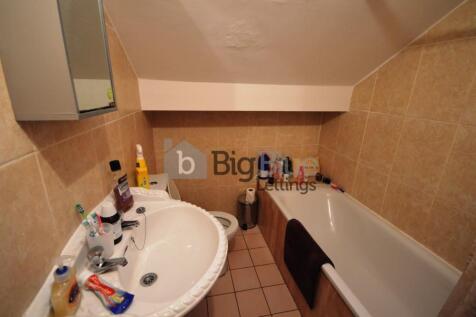 A well-maintained bathroom featuring a white si...
