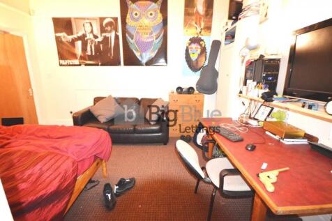 Cozy single bedroom featuring a comfortable bed...