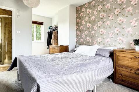 Bright and inviting master bedroom featuring a ...