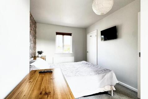 Bright and tidy double bedroom featuring a comf...