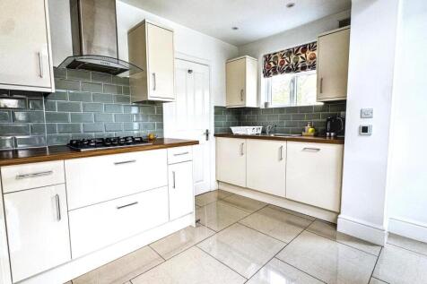 Bright and modern kitchen featuring ample cabin...