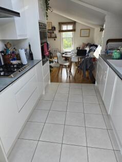 Bright and modern kitchen with sleek white cabi...