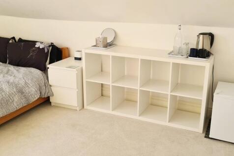 Cozy and tidy bedroom featuring a comfortable s...