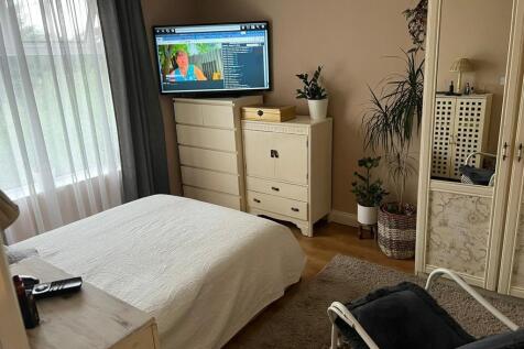A cozy double bedroom featuring a neatly made b...