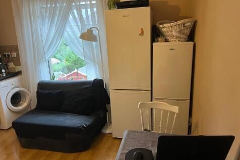 A cozy kitchen area featuring a washing machine...