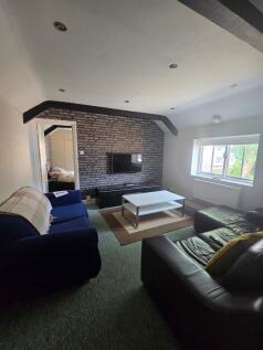 A cozy living room featuring a comfortable leat...