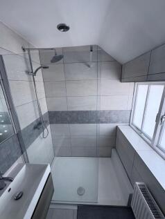 A modern and tidy bathroom featuring a spacious...