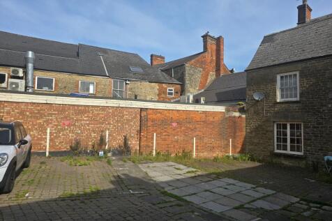 Sunny view of the front exterior of a charming ...